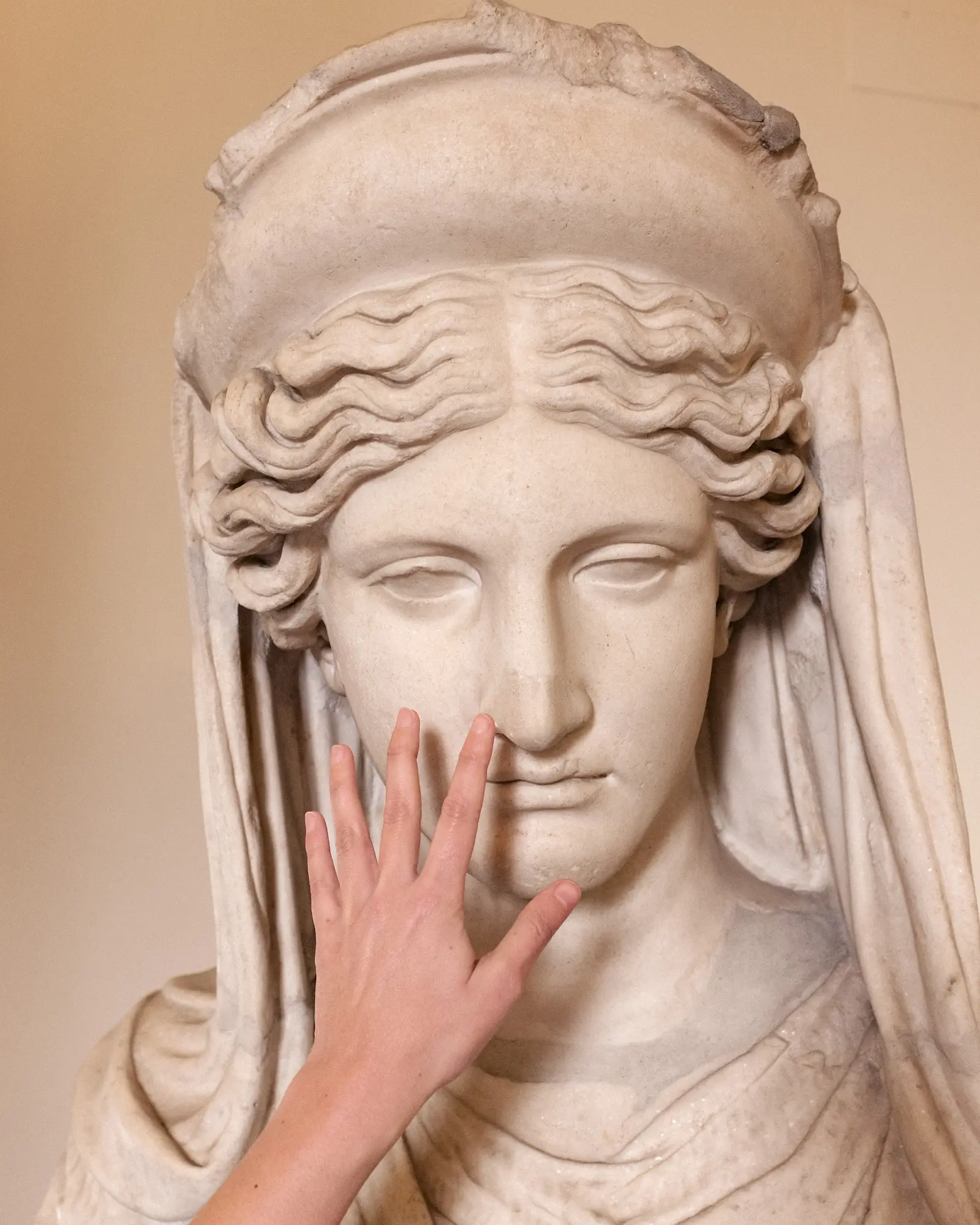 Hand grasping a statue